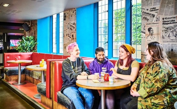 Four friends chatting in a bar